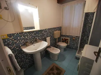 a bathroom with a sink and a toilet and a mirror at kappa's house a granni in Palermo