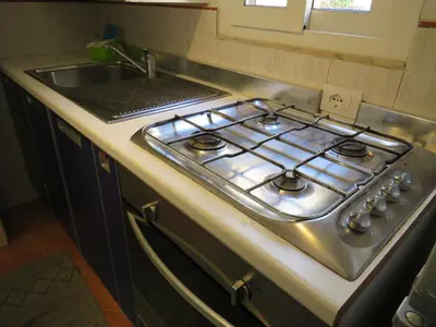 a stove top in a kitchen next to a sink at Loft with terrace in the city centre in Palermo