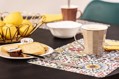 a table with a plate of bread and a cup of coffee at Casa Chicotta- Libertà in Palermo