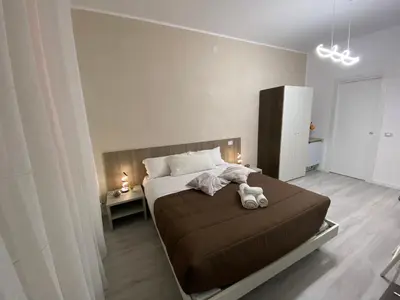 a bedroom with a bed with a teddy bear on it at I Conti della Zisa in Palermo