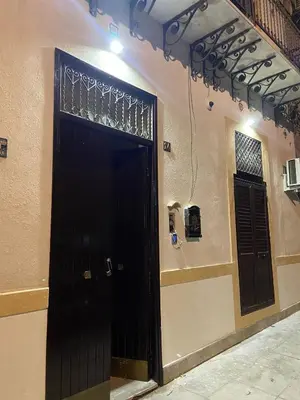 a black door in a room with a wall at I Conti della Zisa in Palermo