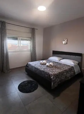 a bedroom with a bed and a window at Mare Blu in Palermo