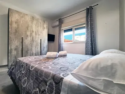 a bedroom with a large bed and a window at Mare Blu in Palermo