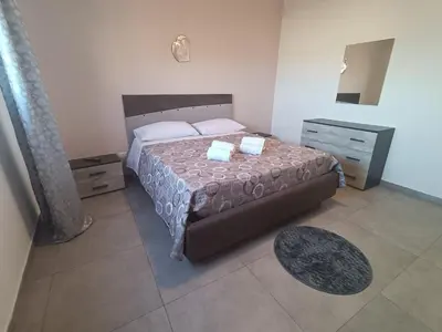 a bedroom with a bed with two towels on it at Mare Blu in Palermo
