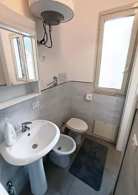 a bathroom with a sink and a toilet at Mare Blu in Palermo