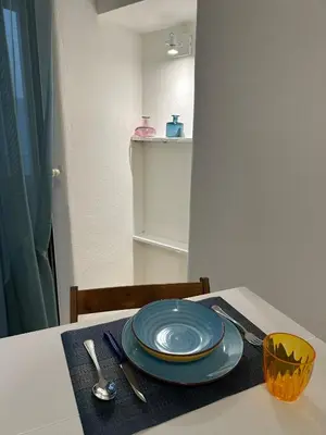 a table with a blue plate on top of it at Blue Charm Exclusive Apartment in Palermo