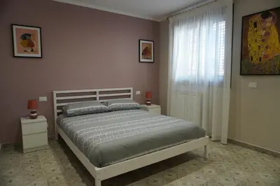 a bedroom with a bed and a window at Maria's Home in Altavilla Milicia