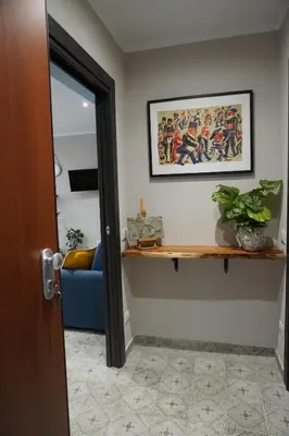 a room with a blue couch and a mirror at Maria's Home in Altavilla Milicia