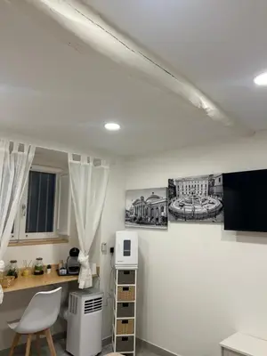 a kitchen with white walls and a white microwave at All'Oro Suite & go in Palermo
