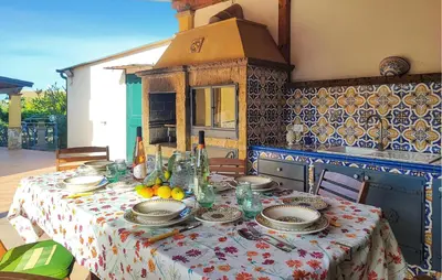 a table with plates and bowls on top of it at Stunning Home In Trabia in Trabia