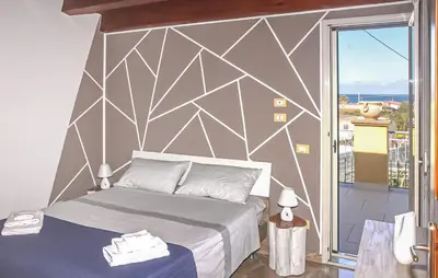 a bedroom with a bed and a large window at Stunning Home In Trabia in Trabia