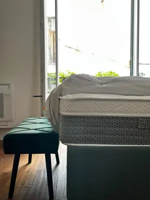 a bed and a chair in a room with a window at Rosalia Holiday Home in Palermo