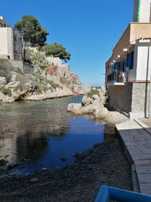 a river next to some buildings on a hill at Terrazza al mare in Santa Flavia