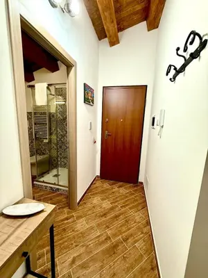 a bathroom with a shower and a wooden door at A Casa di Frank in Palermo
