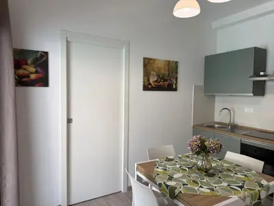 a kitchen and dining room with a table and chairs at Sguardo a Ponente in Castellammare del Golfo