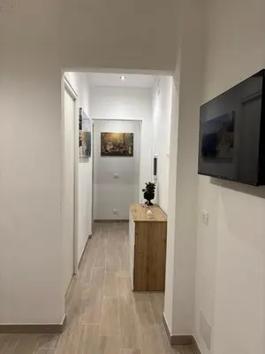 a hallway with white walls and a television on a wall at Sguardo a Ponente in Castellammare del Golfo