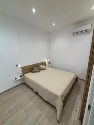 a bedroom with a bed in a white room at Sguardo a Ponente in Castellammare del Golfo