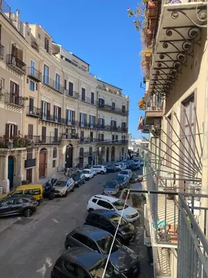 a city street with cars parked in front of buildings at Appartamento Nonna Rosalba in Palermo