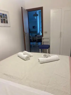 a white bed with two towels on top of it at Appartamento Nonna Rosalba in Palermo