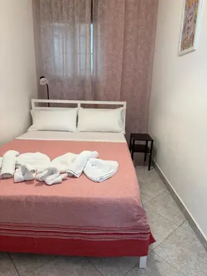 a bedroom with a bed with towels on it at Appartamento Nonna Rosalba in Palermo