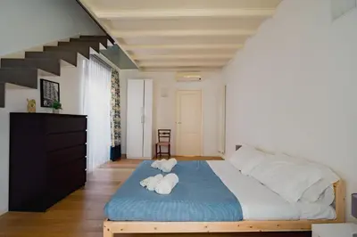 a bedroom with a bed with two towels on it at Santa Sofia con Terrazza by Wonderful Italy in Palermo