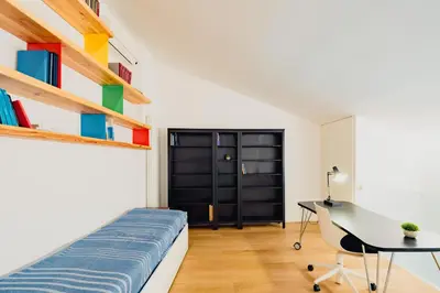 a bedroom with a bed and a desk and a window at Santa Sofia con Terrazza by Wonderful Italy in Palermo