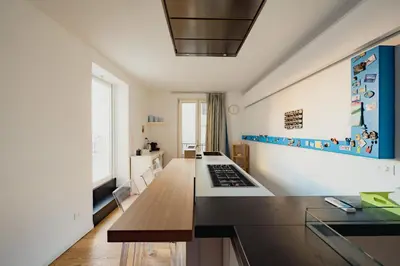 a kitchen with a counter and a tv in a room at Santa Sofia con Terrazza by Wonderful Italy in Palermo