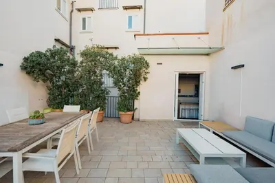a patio with a wooden table and chairs at Santa Sofia con Terrazza by Wonderful Italy in Palermo