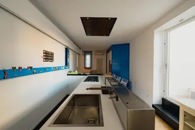 a kitchen with blue and white walls at Santa Sofia con Terrazza by Wonderful Italy in Palermo
