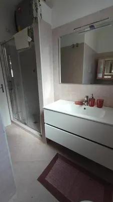 a bathroom with a sink and a shower with a mirror at Casa GADA in Palermo