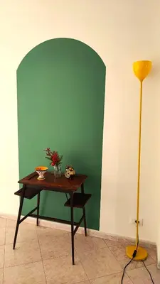 a table in a room with a green wall at Casa GADA in Palermo