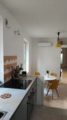 a kitchen with a counter and a table with chairs at Casa GADA in Palermo