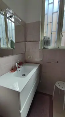 a bathroom with a white sink and a mirror at Casa GADA in Palermo