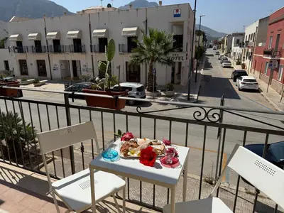 a plate of food sitting on a table on a balcony at Carol's Sicily Dream in San Vito lo Capo