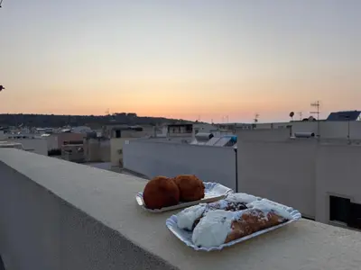 two pastries sitting on a ledge on a balcony at Carol's Sicily Dream in San Vito lo Capo