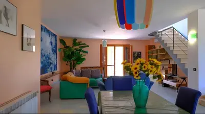 a living room with a vase of flowers on a table at Villa Viola e Giulio in Scopello