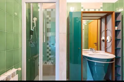 a bathroom with a sink and a glass shower at Villa Viola e Giulio in Scopello