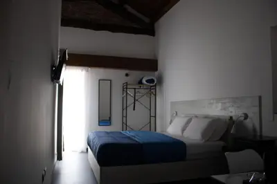 a bedroom with a bed with a blue blanket at Dimora Garibaldi in Palermo