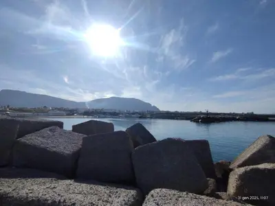 a group of rocks in front of a body of water at Casa Kialy in Terrasini
