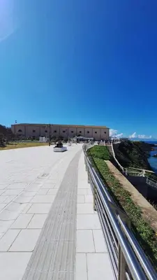 a walkway next to a building and the ocean at Casa Kialy in Terrasini