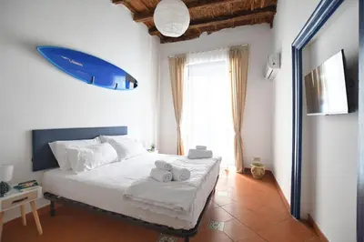 a bedroom with a bed with a surfboard on the wall at iFlat Casa Riccino in Palermo