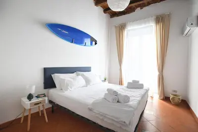 a bedroom with a bed with a surfboard on the wall at iFlat Casa Riccino in Palermo