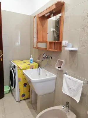 a bathroom with a sink and a washing machine at Albachiara in Balestrate