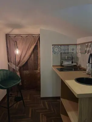 a kitchen with a sink and a table with a chair at Ausa 20 - Tra Storia e Mare in Palermo
