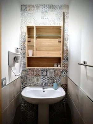 a bathroom with a sink and a cupboard at Guest House Lo specchio sul mare in Santa Flavia