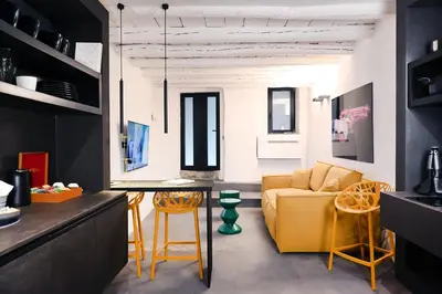 a living room with a yellow couch and a table at Suitt Drims 6 in Palermo