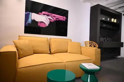a couch in a living room with a picture on the wall at Suitt Drims 6 in Palermo