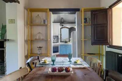 a kitchen with a wooden table with fruit on it at Villa Passulunara 14 by Massimo Villas in Lascari