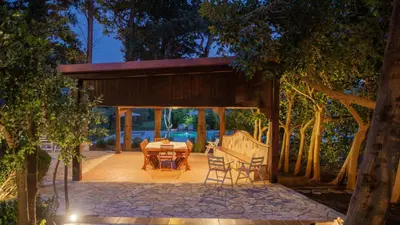 a pavilion with a table and chairs on a patio at Casale Buccellato 14 by Massimo Villas in Castellammare del Golfo