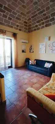 a living room with a blue couch in a room at casa Fontana in Capaci